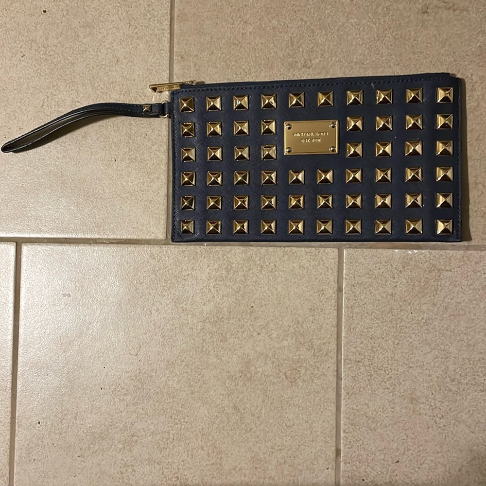 Michael Kors XL Navy/Gold studded wristlet. Good pre-owned condition.